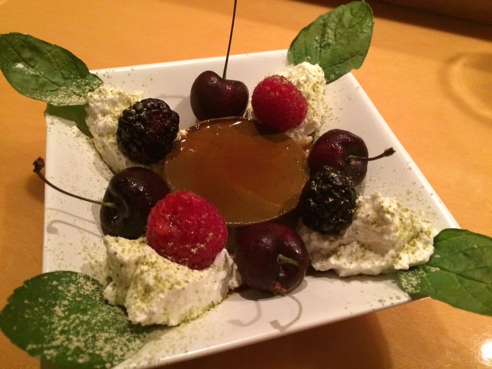 Dessert with cherries, berries and cream